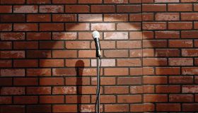 Microphone on stand in front of brick wall