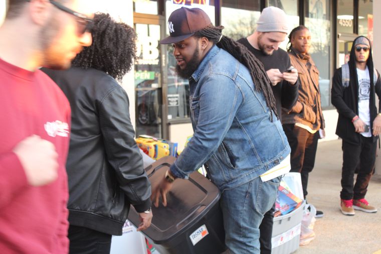 Drique London dropping of a tub of toys