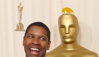 US actor Denzel Washington holds his Oscar after