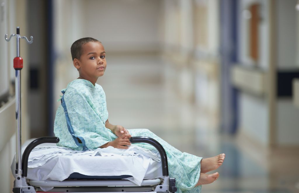 Mixed Race boy in hospital gown