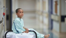 Mixed Race boy in hospital gown