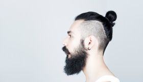 Profile of man with beard and half shaved hair