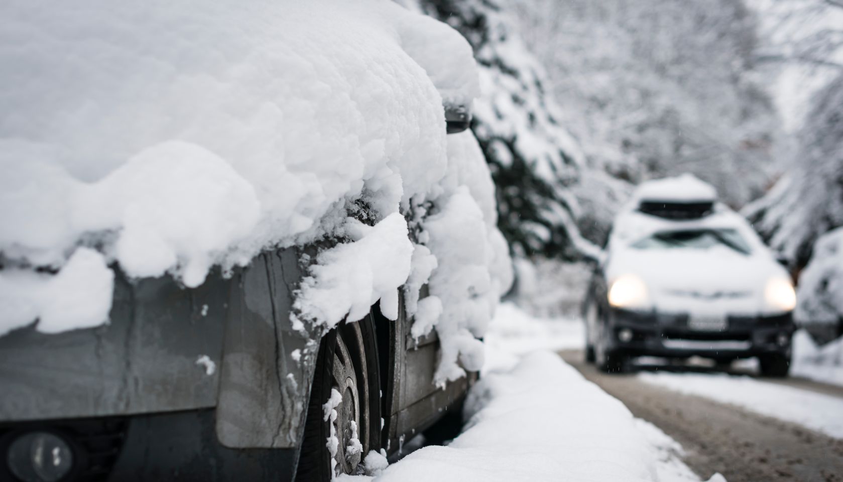Snow-covered street and car