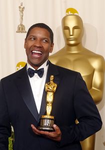 US actor Denzel Washington holds his Oscar after