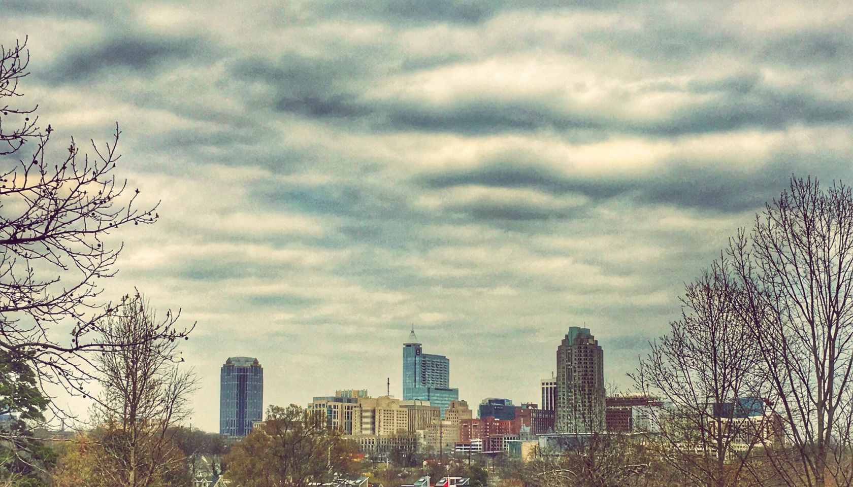 View Of Cityscape Against Cloudy Sky