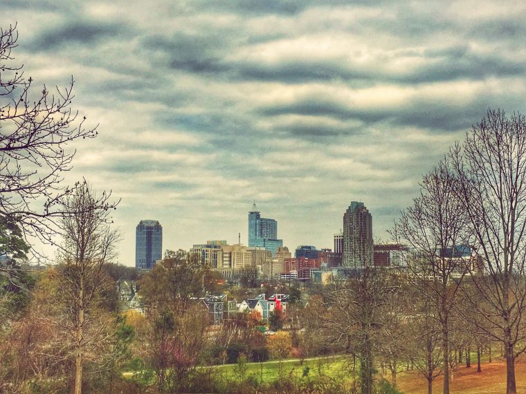 View Of Cityscape Against Cloudy Sky