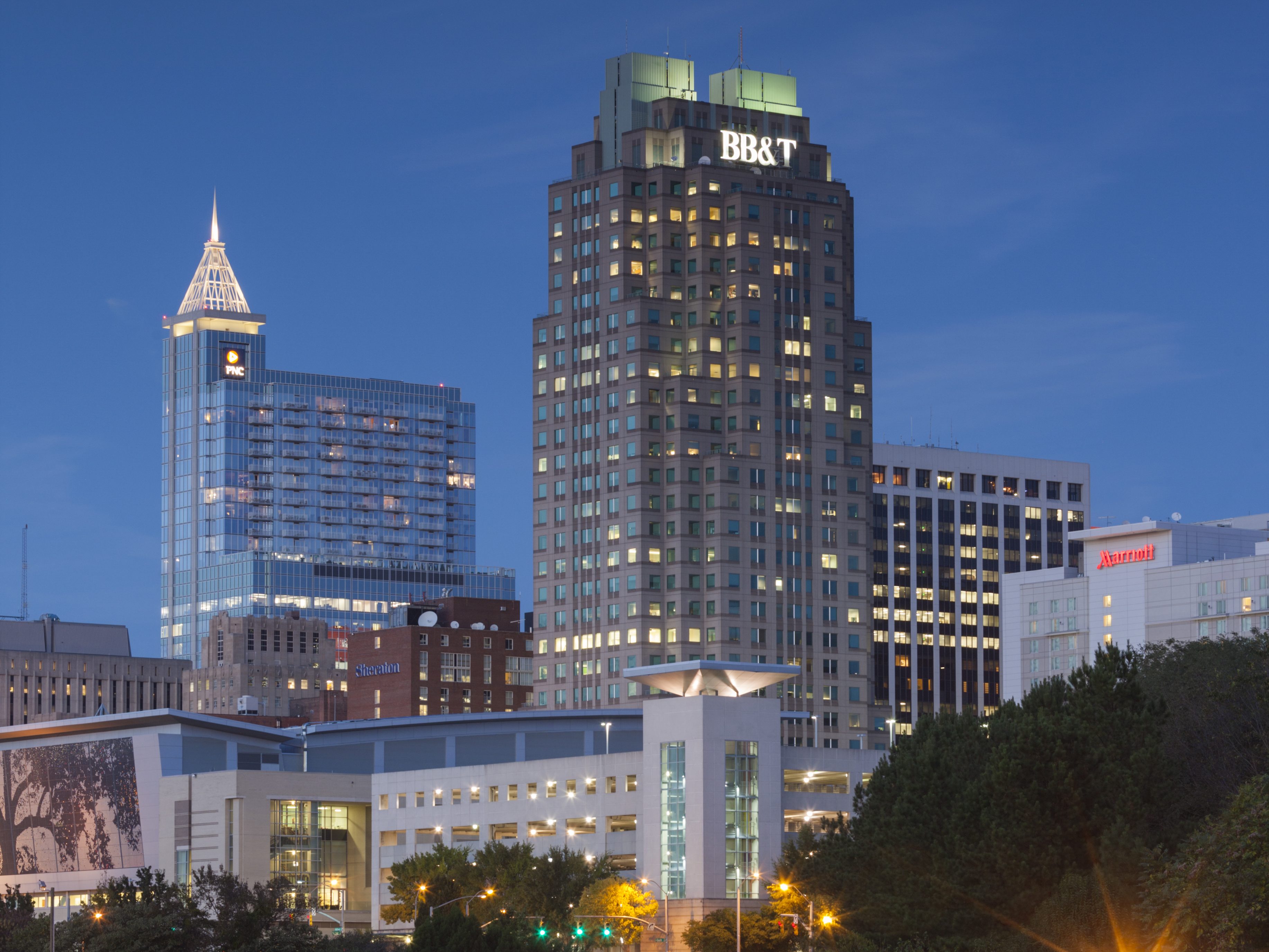 Empty road with urban skyline on background at dusk, Raleigh, North Carolina, USA