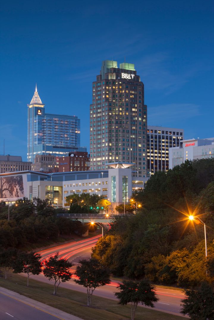 Empty road with urban skyline on background at dusk, Raleigh, North Carolina, USA