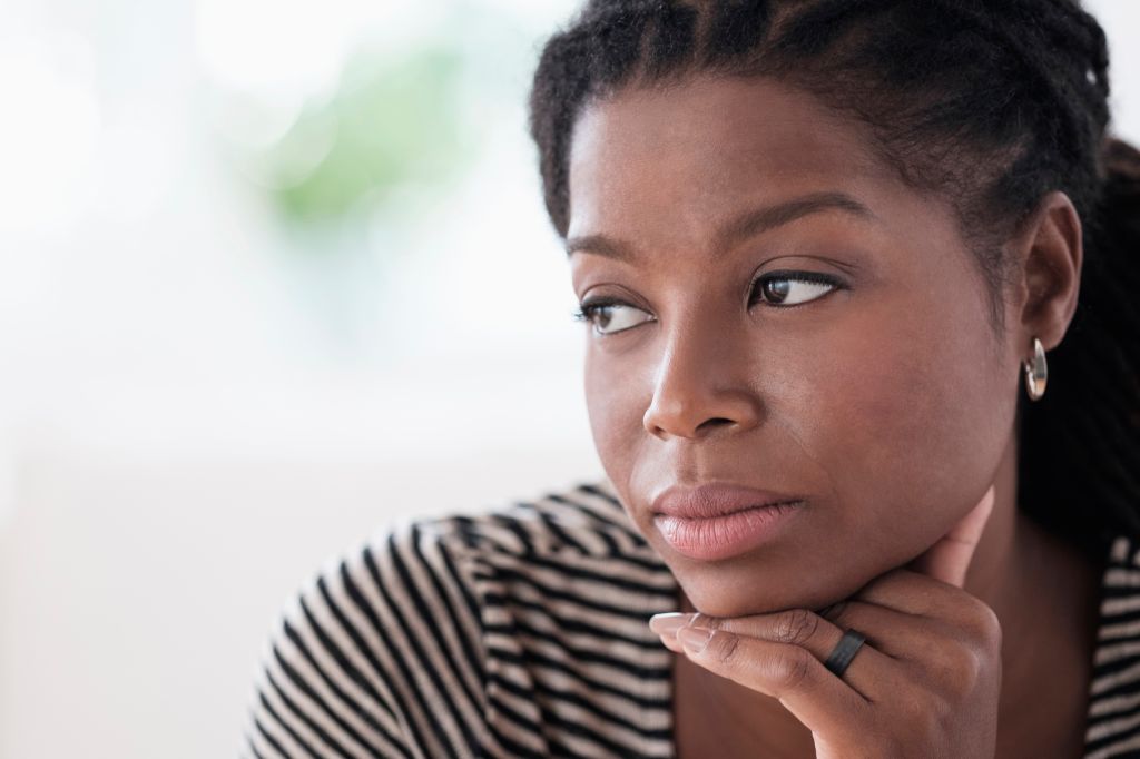 Black woman resting chin in hand