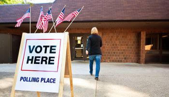 Woman Voter Entering Voting Polling Place for USA Government Election