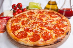 Pizza diavola on a white background with ingredients around