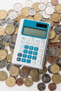 A calculator is on a pile of coins