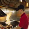 Fast food worker flips hamburgers