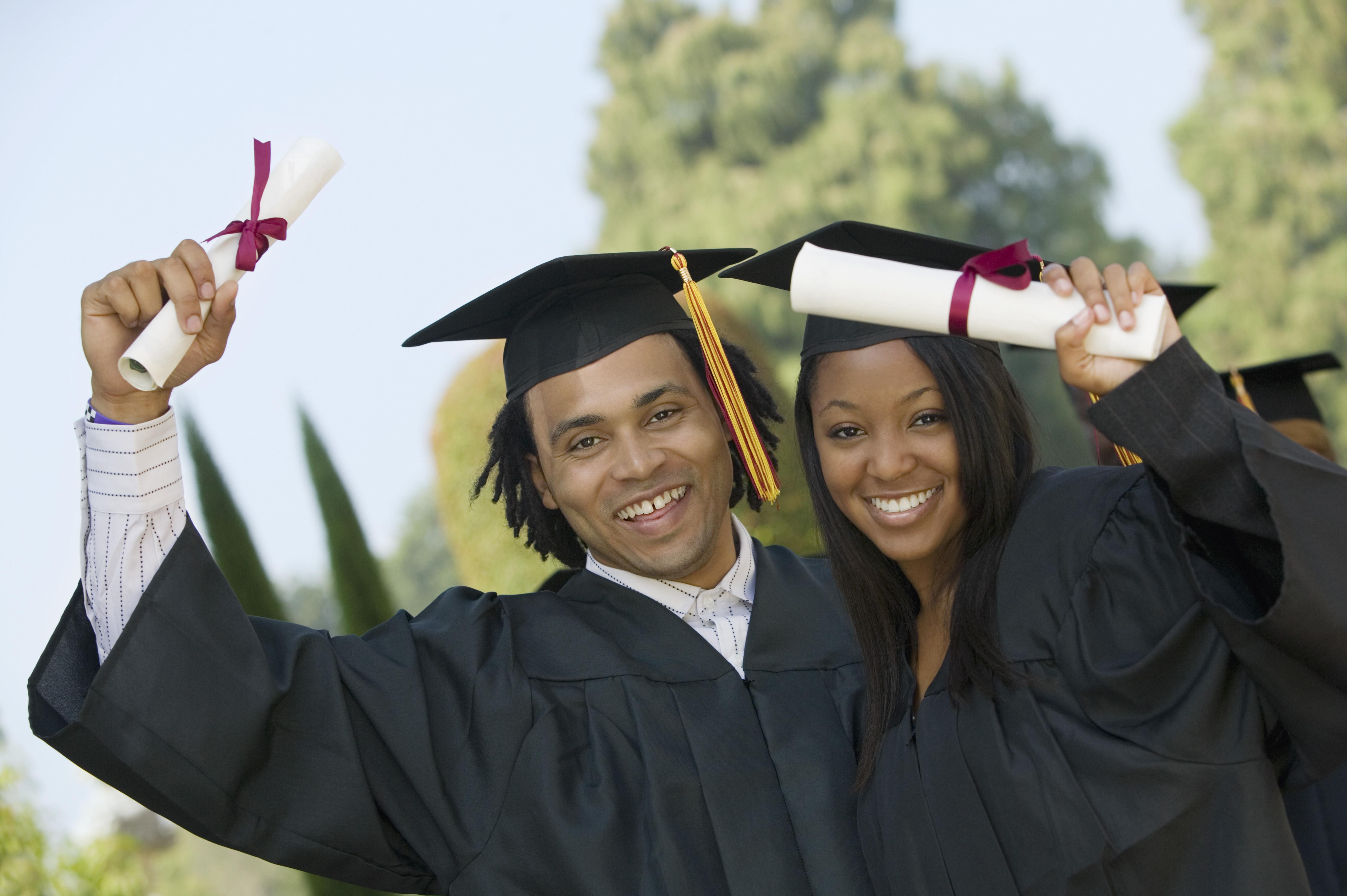 Graduates Holding Diplomas