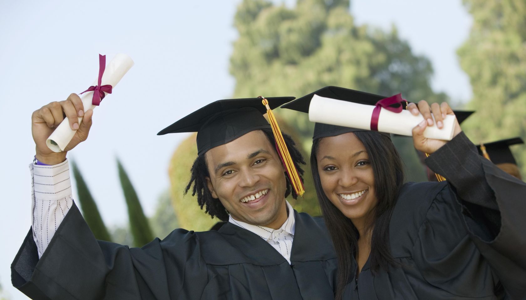 Graduates Holding Diplomas