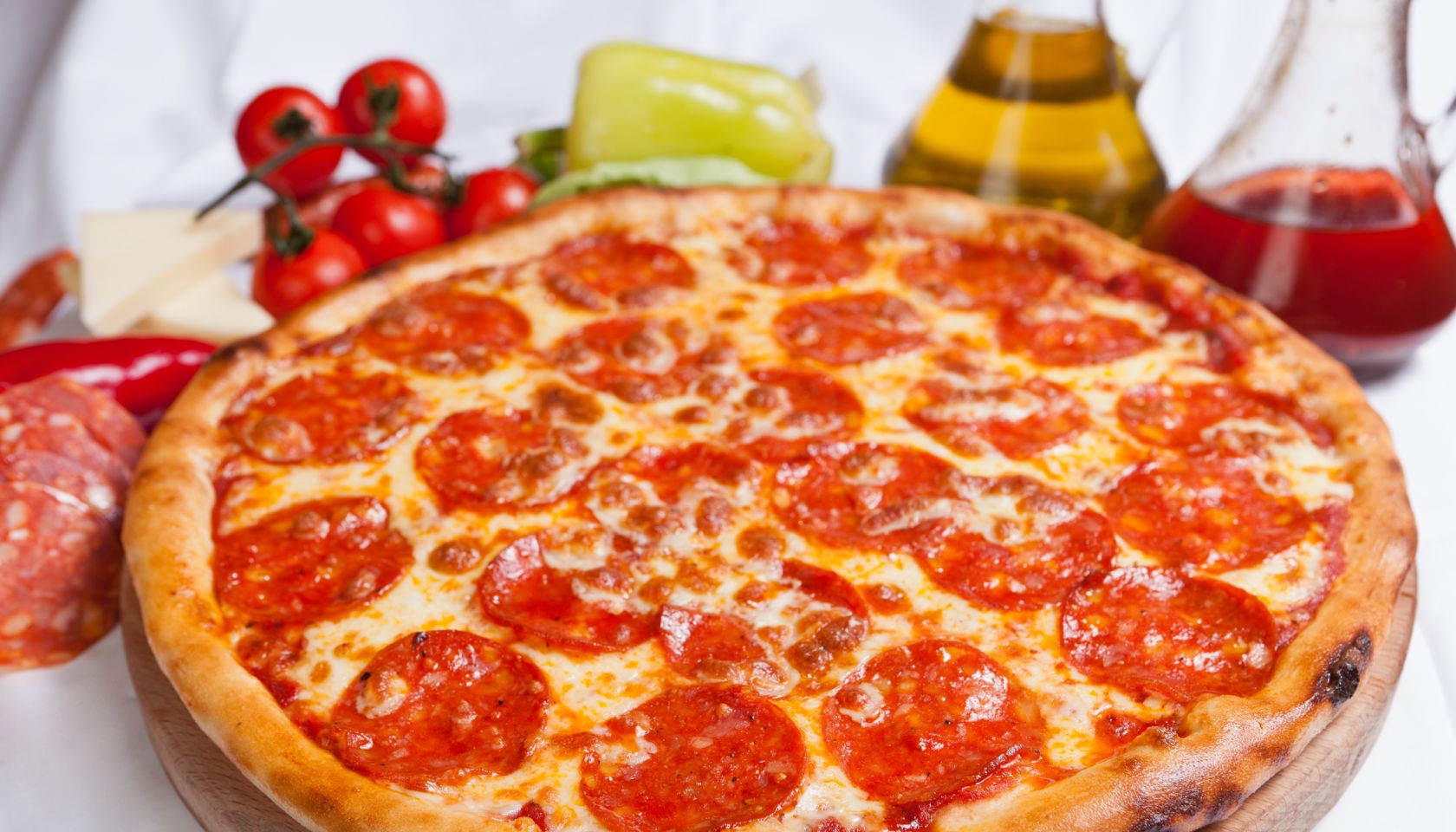 Pizza diavola on a white background with ingredients around