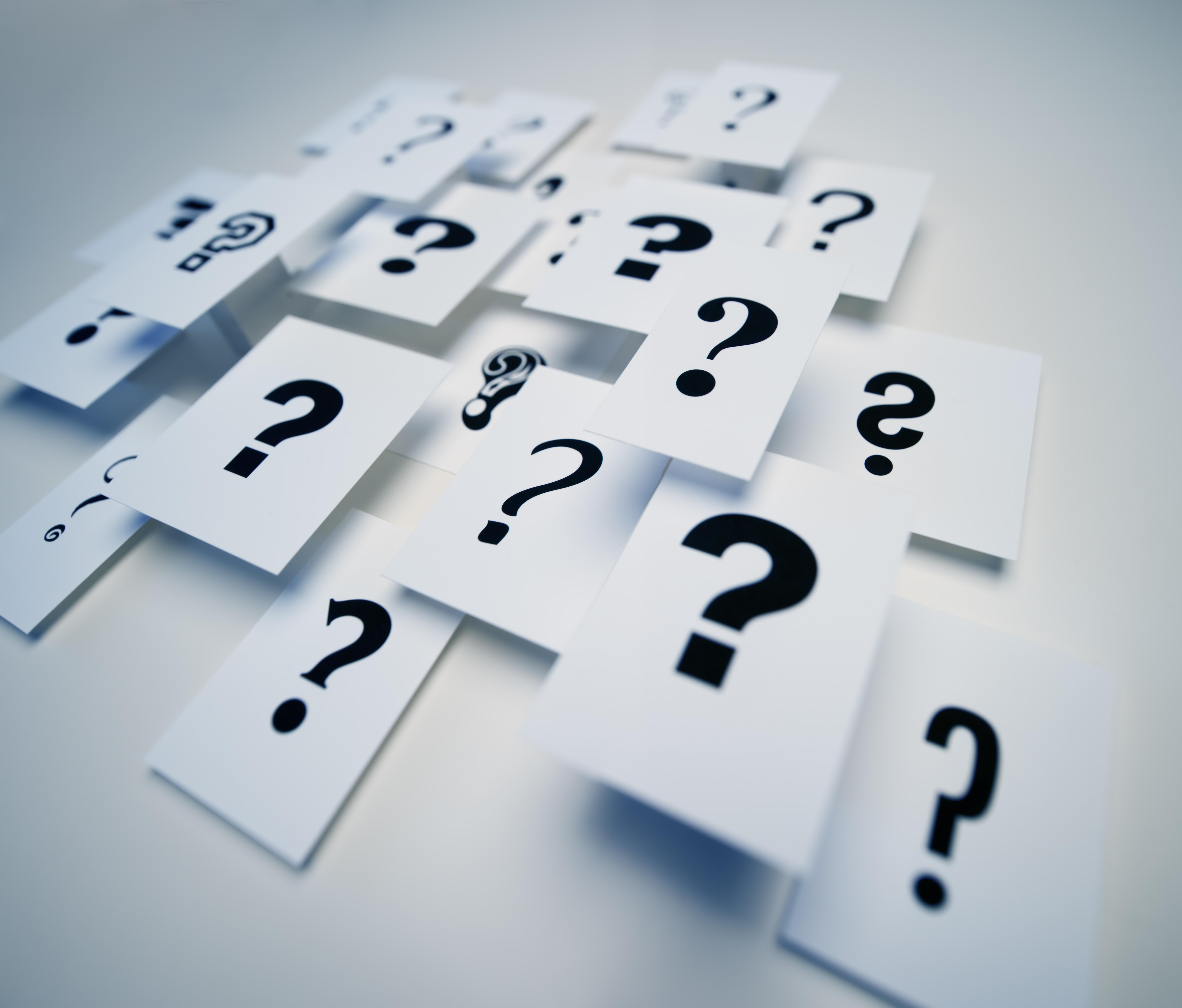 Multiple question marks on paper