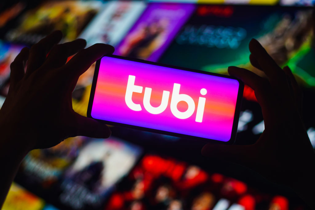 In this photo illustration, the Tubi logo is displayed on a...