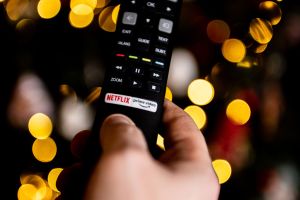 In this photo illustration a tv remote with Netflix logo is...