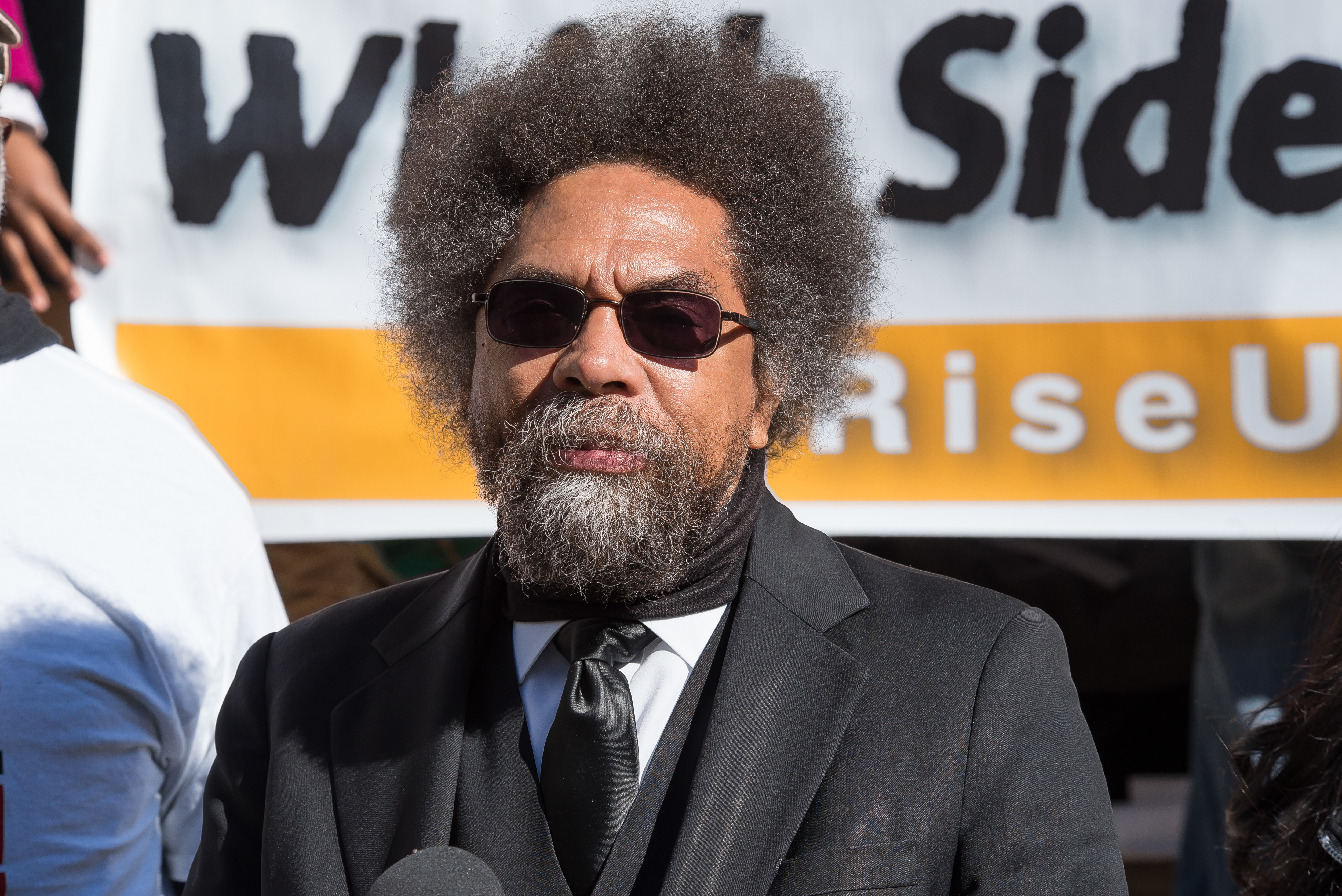 Dr. Cornel West speaks to the press at the City Hall press...