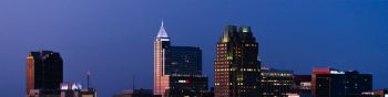 Illuminated office buildings rise in night Downtown Raleigh in North Carolina