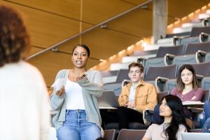 Female student asks college professor a question