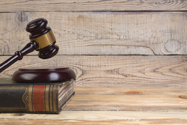 Judge gavel on the book on wooden table. justice and law concept.