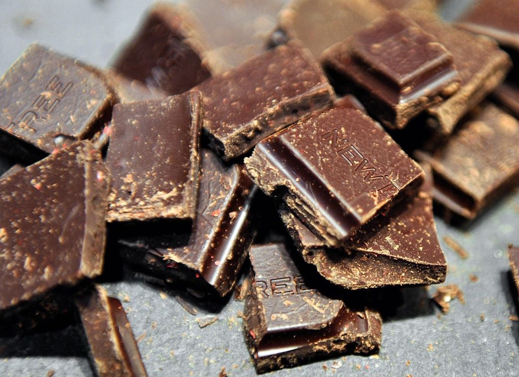 A woman takes a piece of chocolate displ